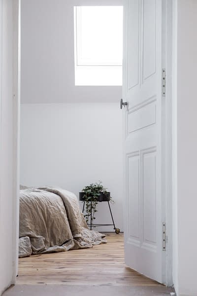 white door opening onto bedroom