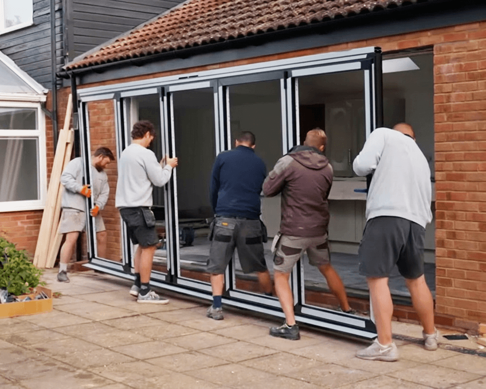 Several men installing an external bifold door