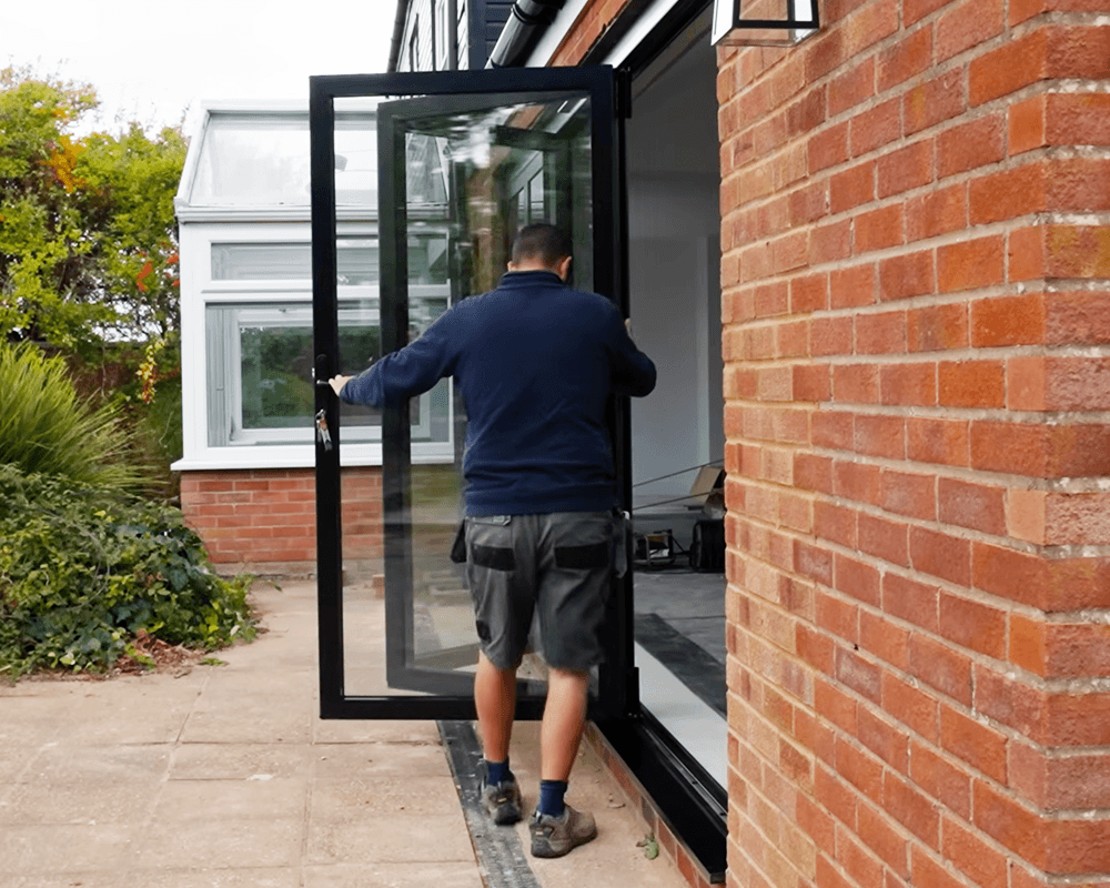Installer checking an external bifold door set