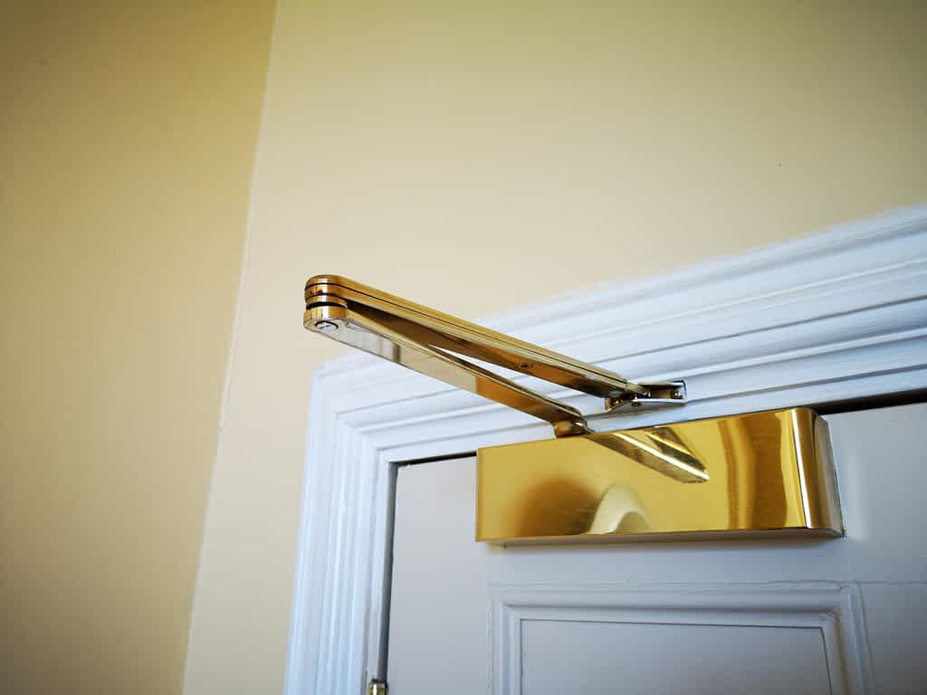 a gold door closer