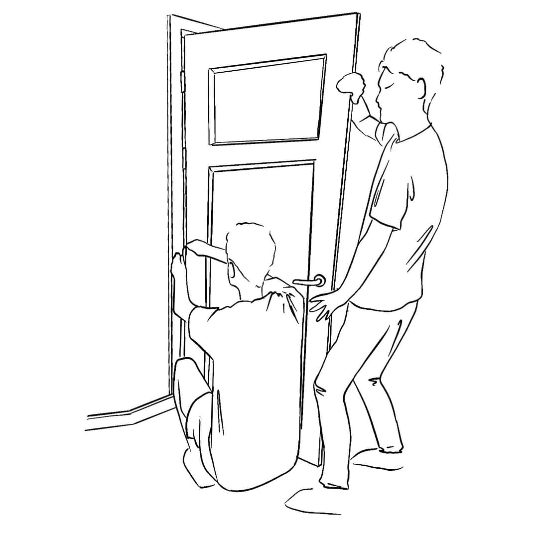 two people putting a door back on the frame together