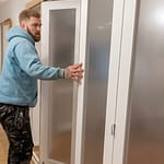 Man fitting internal bifold doors