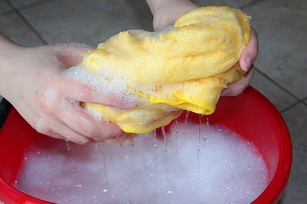 Bucket of soapy water with a cloth