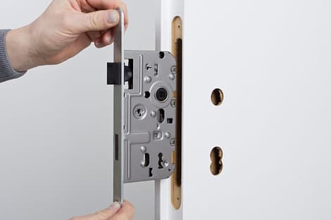 A mortise lock being placed inside a door