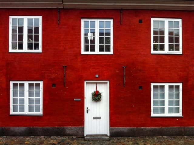 Red House WIth Front Door Decorated For Winter