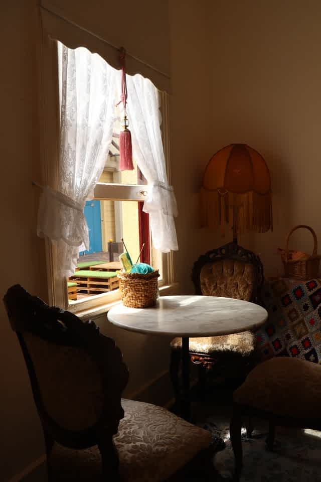 Chintz chairs and lace drapes are an interior design trend for 2022