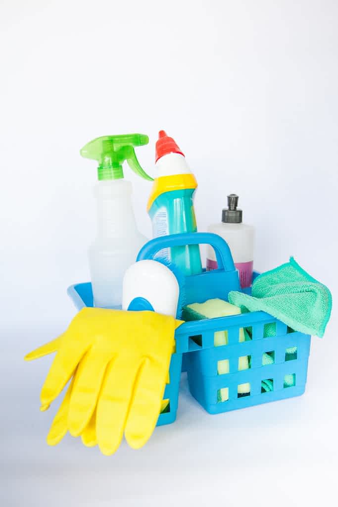a cleaning hamper filled with cleaning supplies