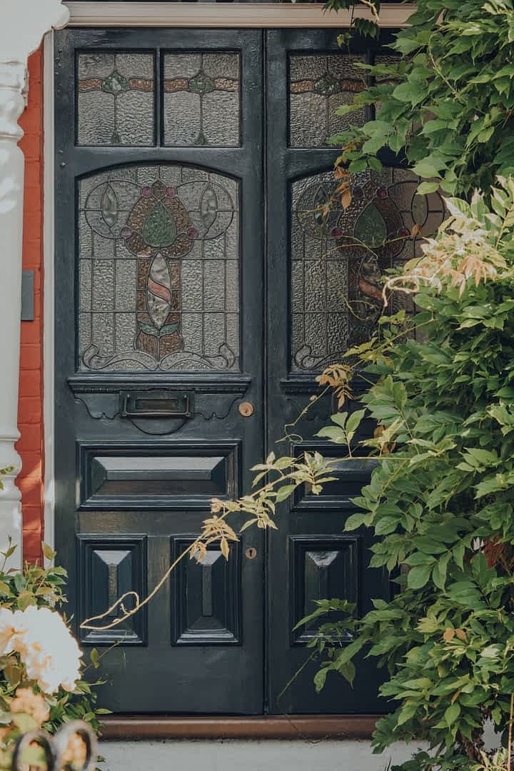 An intricately decorated pair glazed Edwardian doors with stained glass