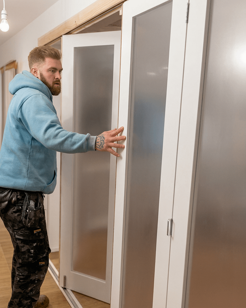 Man fitting internal bifold doors