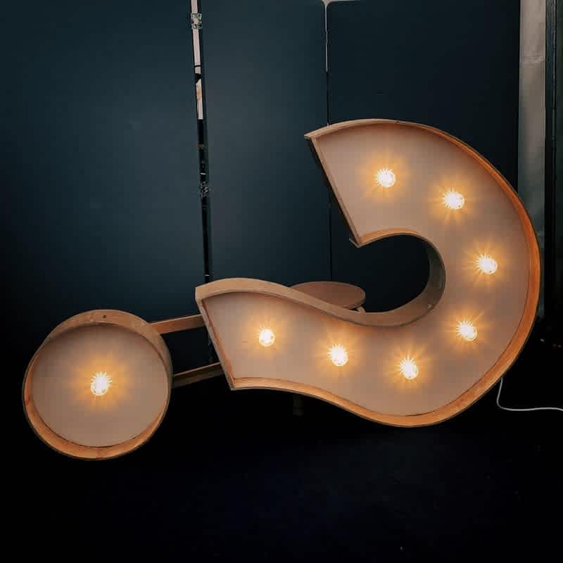 blog asset photo of a big question mark sign with light bulbs inside