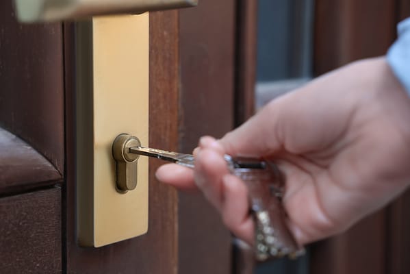 A key unlocking a mortice lock on a door.